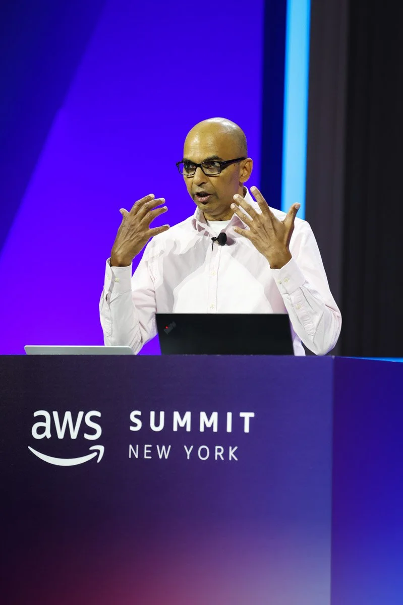 Industry leaders speaking on a panel at the Amazon Web Services Summit at the Javits Center in New York City