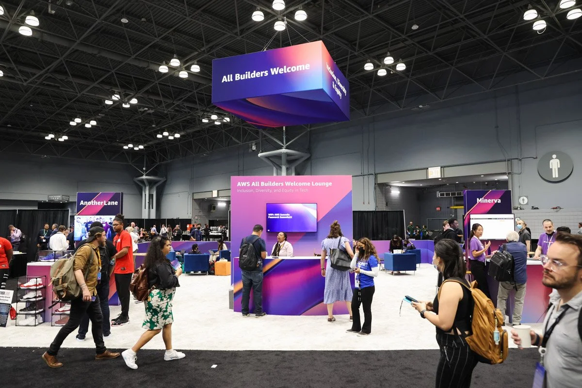 Busy corporate exhibitors showcasing technology solutions at the Amazon Web Services Summit at the Javits Center in New York City
