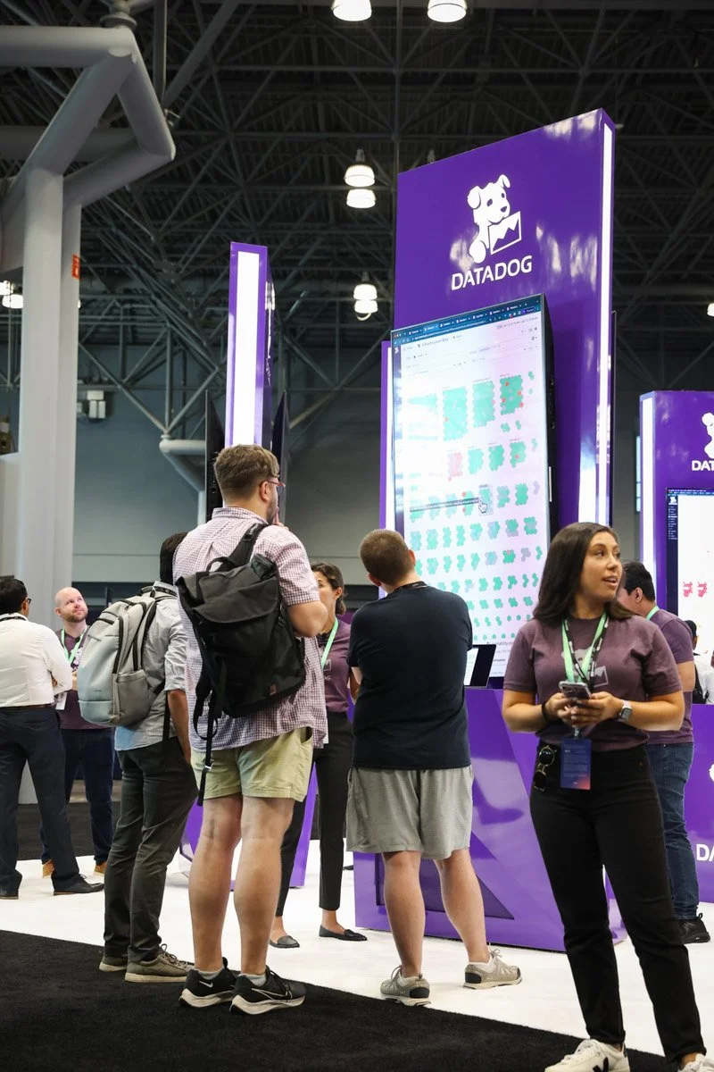 Busy corporate exhibitors showcasing technology solutions at the Amazon Web Services Summit at the Javits Center in New York City