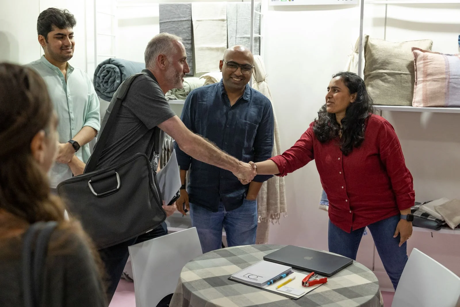 Texworld NYC attendee shaking hands with an exhibitor at Javits Center