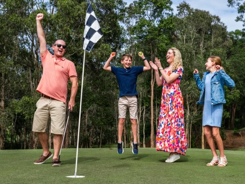 family playing big hole golf
