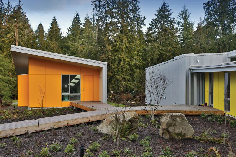 Image Credit: Michael StadlerA bamboo composite walkway connects Mary Jacobson’s studio (orange building) to the main house and other buildings.