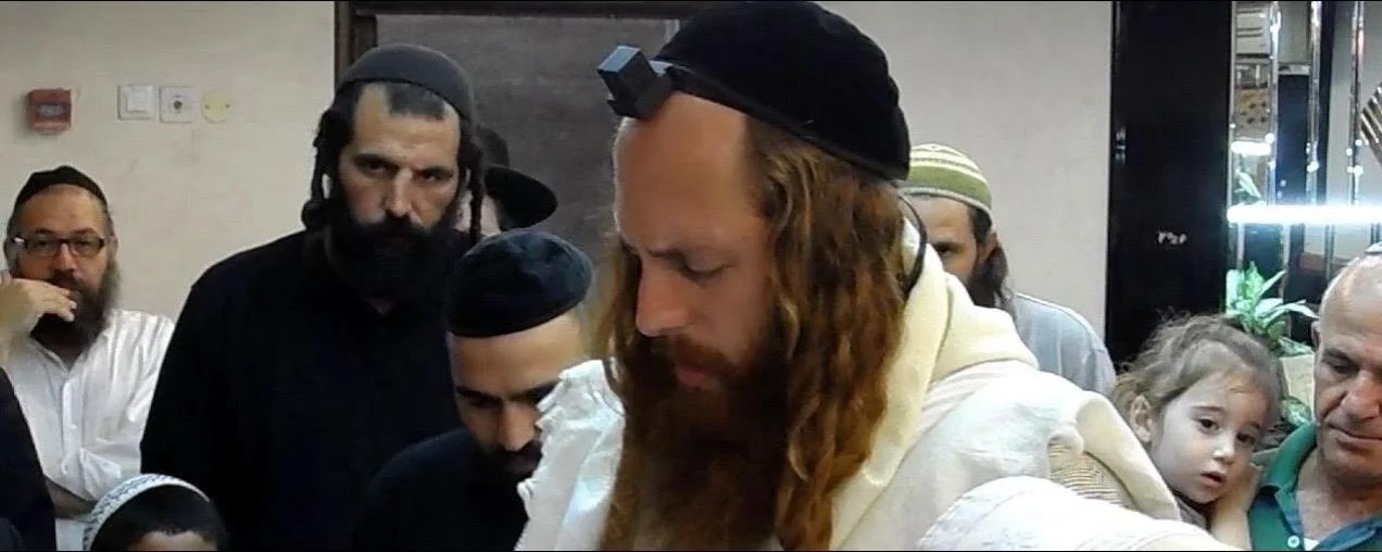 Rav Dror wearing tefillin during prayer