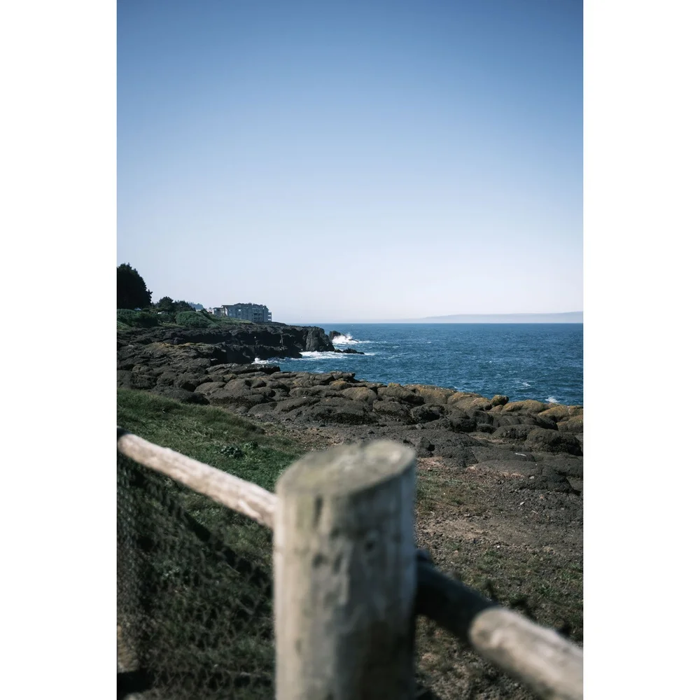 Oregon Boiler Bay State Scenic Viewpoint fence post and coast cliffs