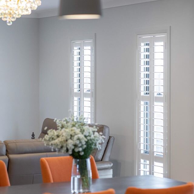 Sleek shutters. A perfect fit for these narrow windows. 
Allowing you to completely control the amount of light entering the room. If you have windows where the sun beams in, shutters are a great option for protecting your furniture from the harsh Au