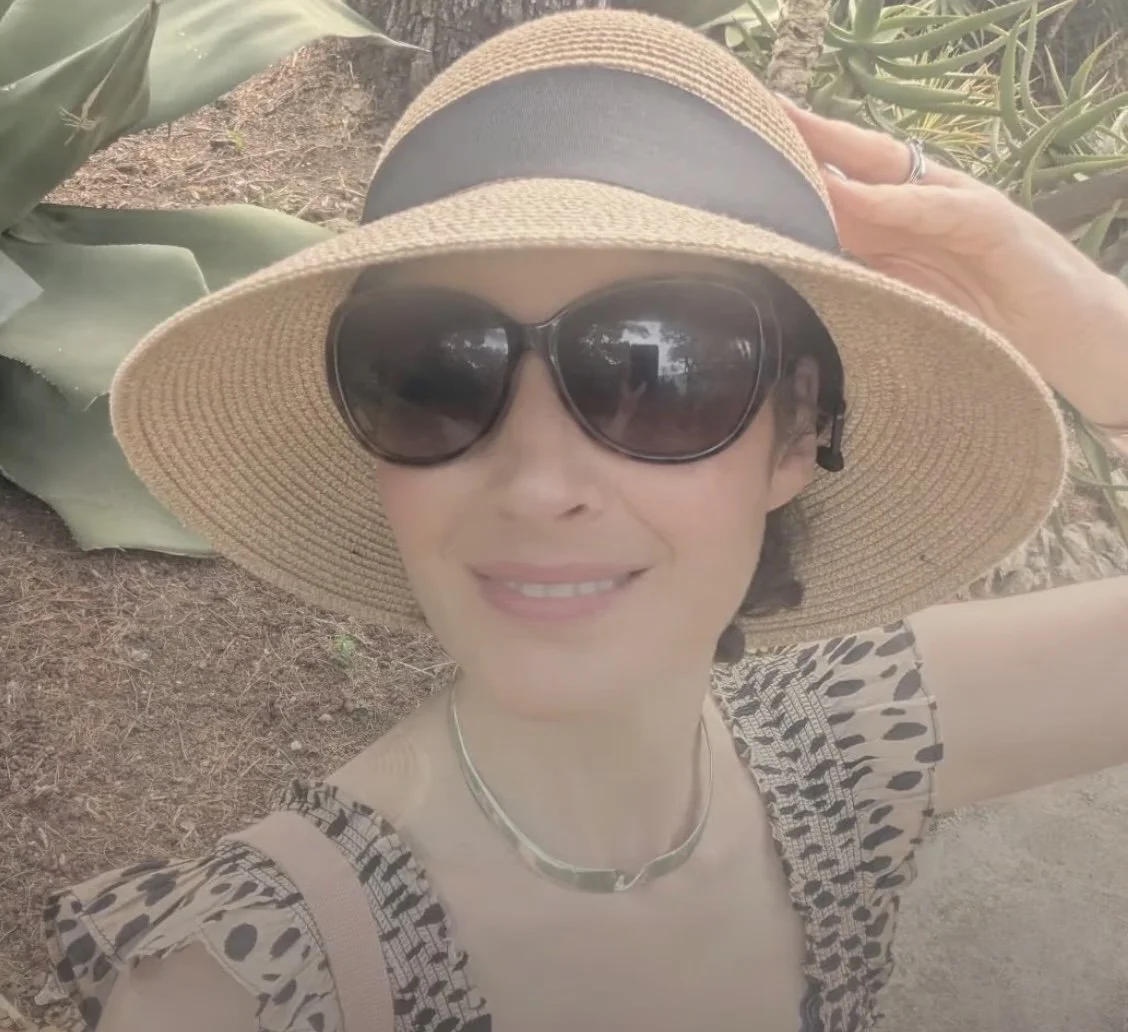 Photo of Dr Kyra in the sun wearing sunglasses and sunhat_Skinphinity_Aesthetics_Clinic_Cheshire
