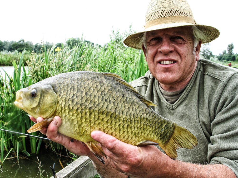 Angling Artist Chris Turnbull with one of the beautiful fish he is working to preserve