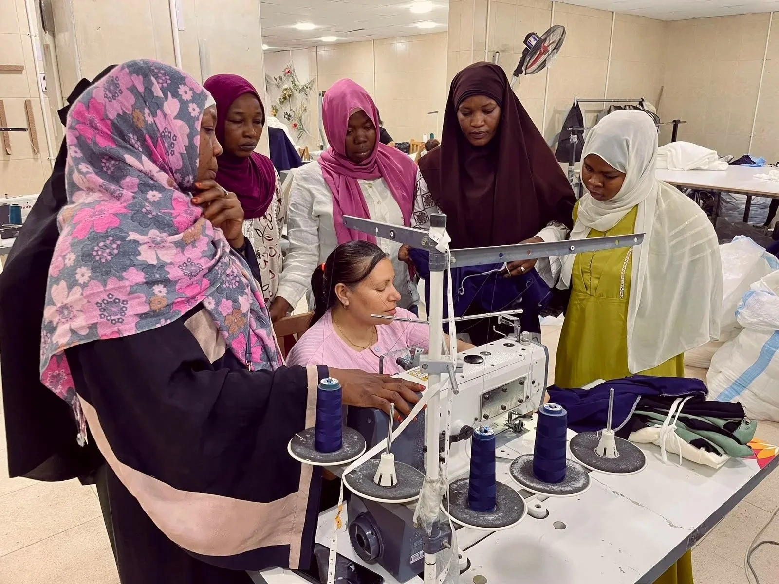 Group of women watching sewing demonstration