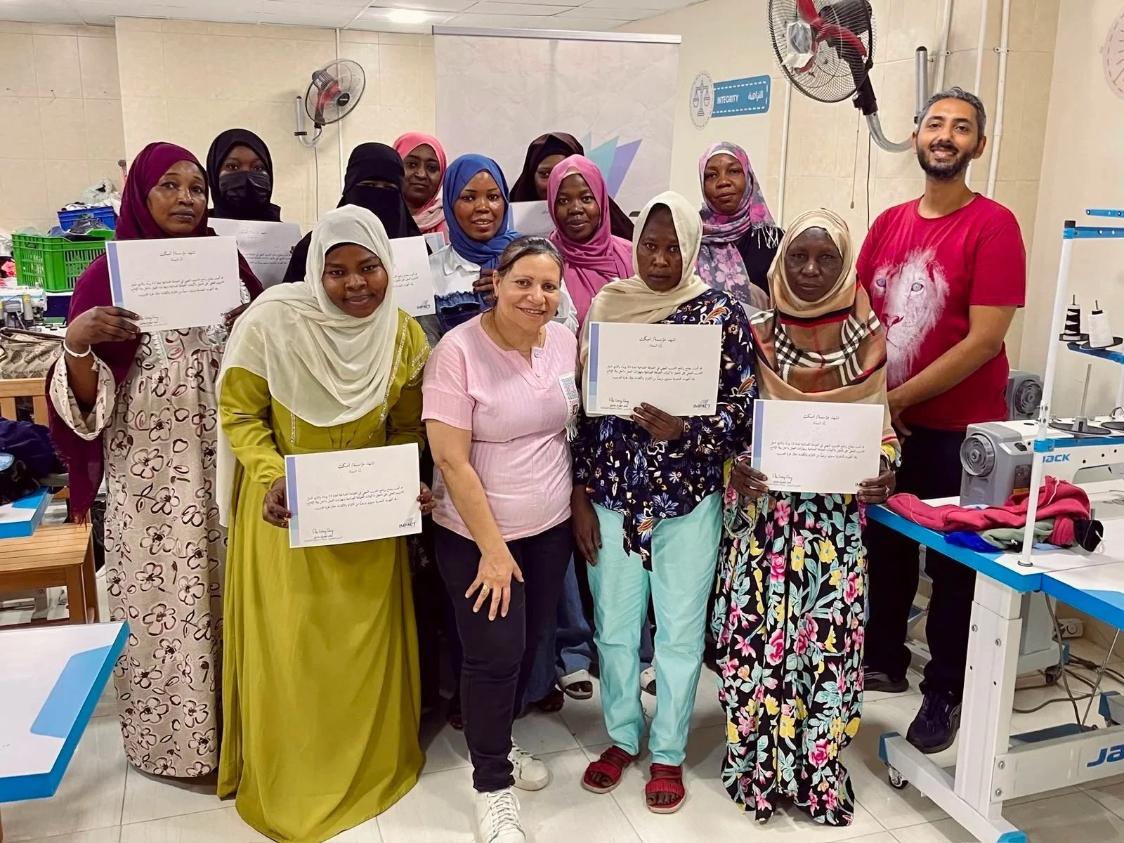 Group of course graduates holding up their certificates