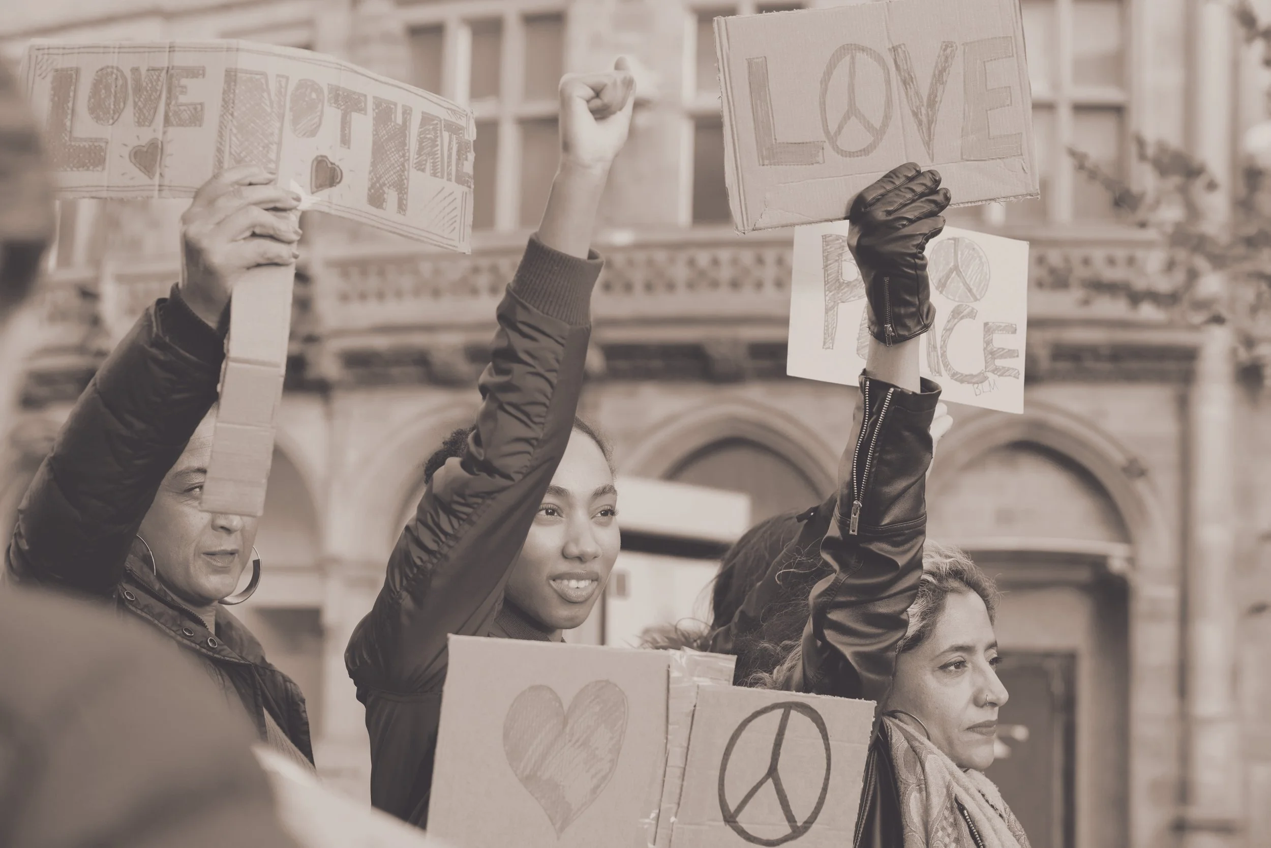 Peaceful protestors hold signs for peace and love