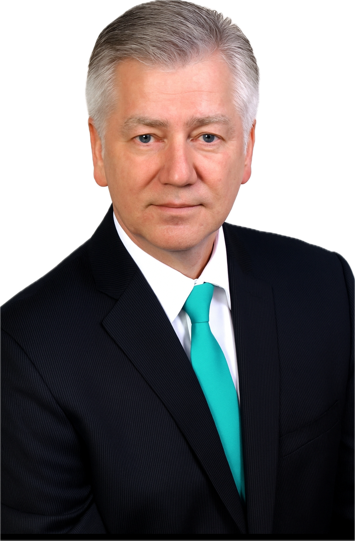 A middle-aged man with short, gray hair, wearing a dark pinstripe suit, white shirt, and turquoise tie, posing against a plain background.