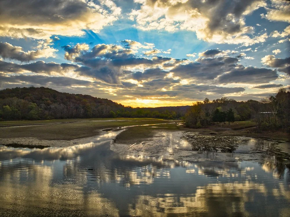 Beautiful Picture of lake barkley taken be John Murphy.  Golden hour sunset with blue sky and beautiful reflection of sky onto the lake.
