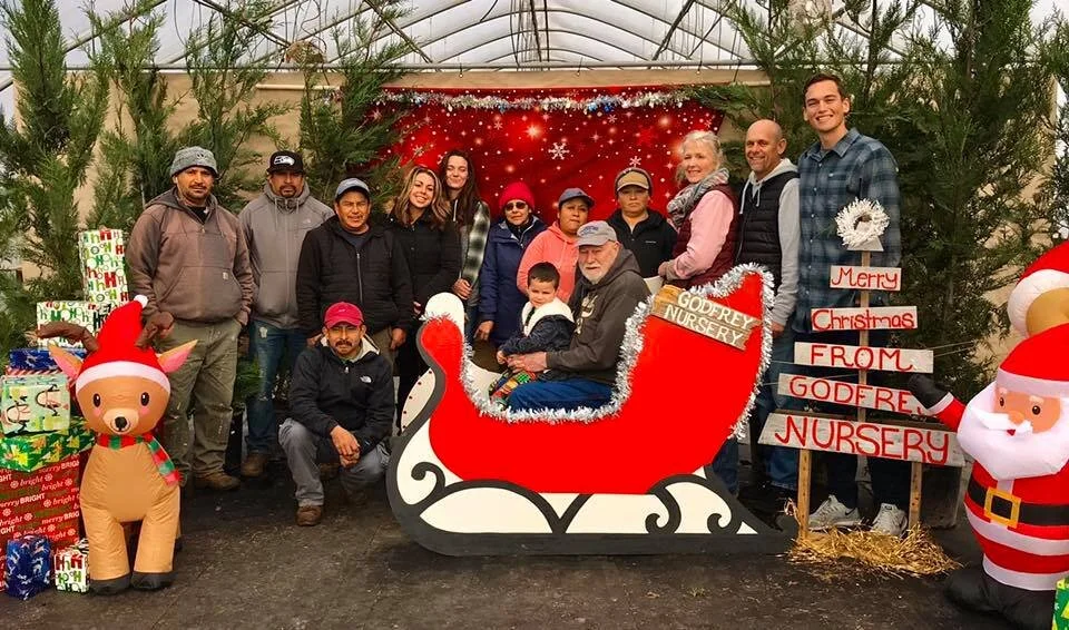 Godfrey Nursery team gathered together during the Christmas season at the garden center.