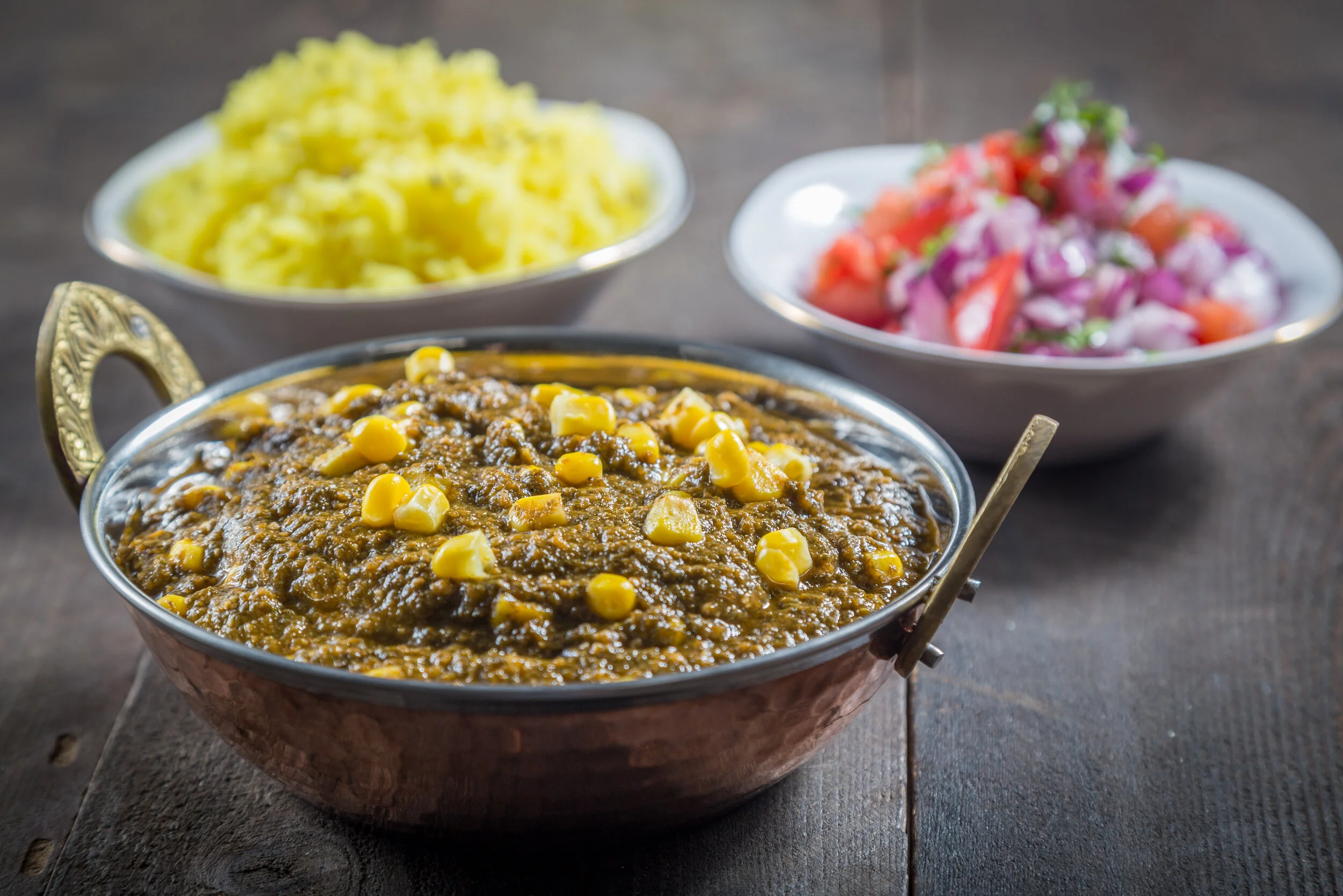 Saag made with leafy green and corn served with rice and chopped salad