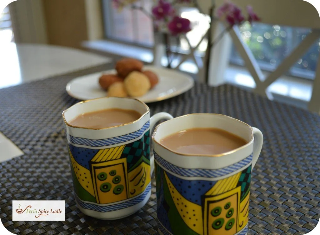 Parsi Choi (Chai tea) in mugs with biscuits