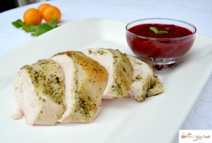 Citrus Mint Turkey on platter with spicy Cranberry sauce in bowl