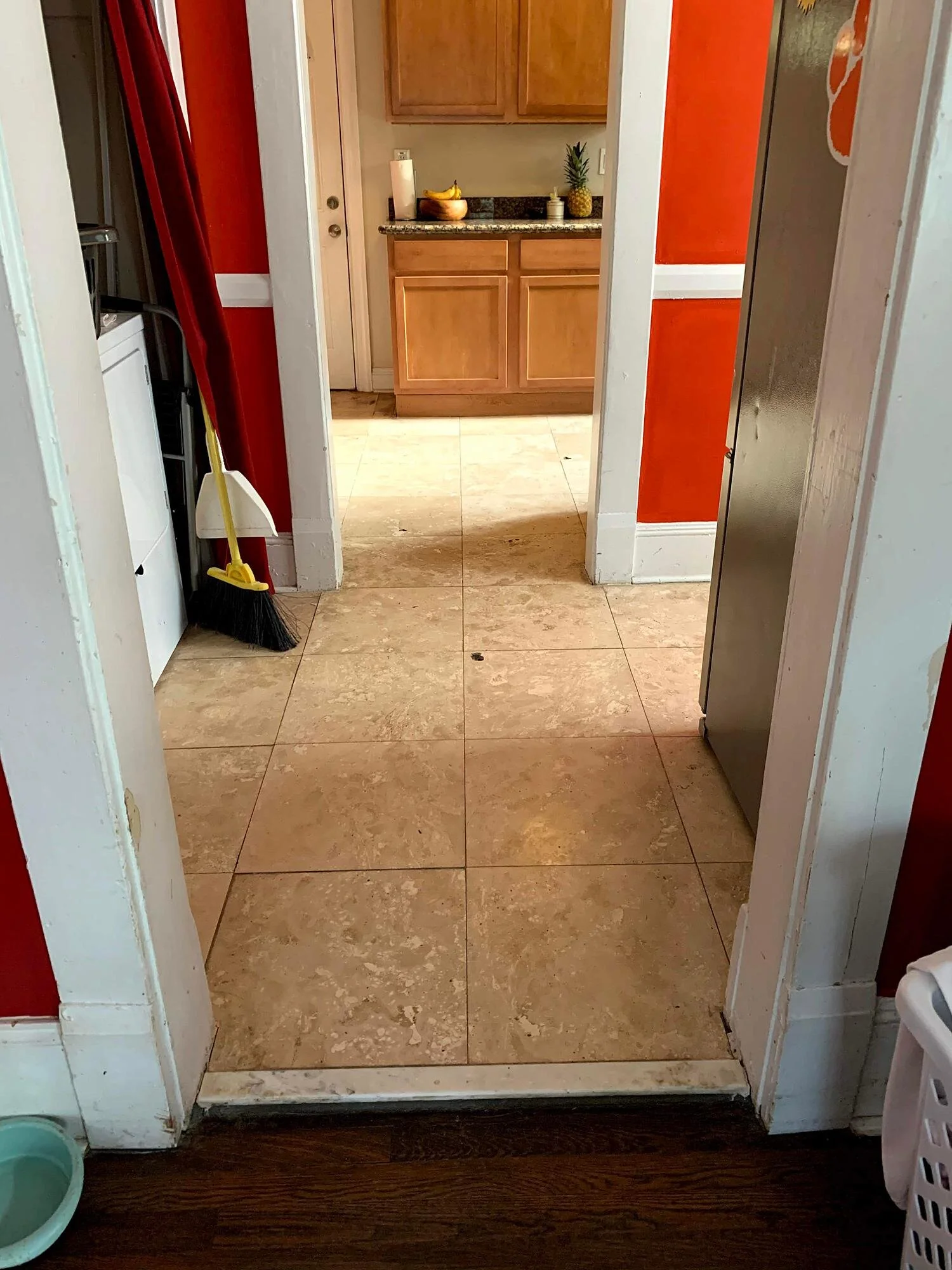 The view into the kitchen (through the refrigerator room) from the dining room.  More holes.