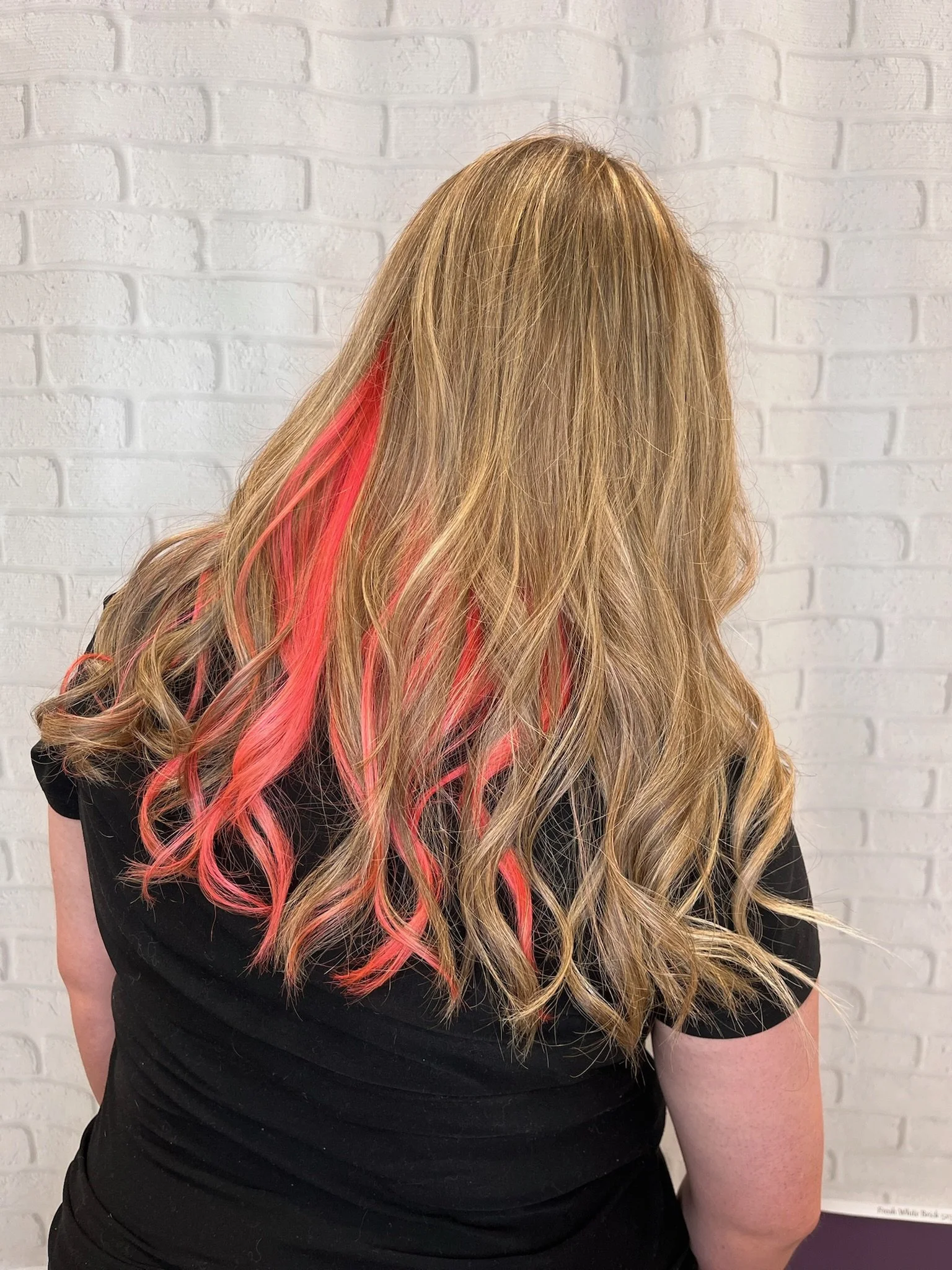 A pop of pink and bright blonde highlights