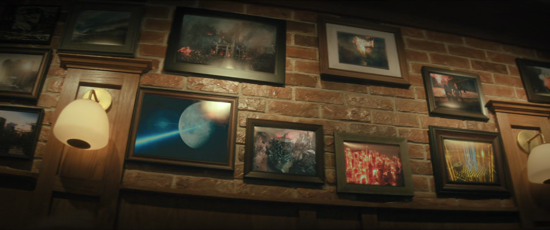 A brick wall decorated with various framed sci-fi and fantasy artwork, including scenes of space, futuristic cityscapes, and apocalyptic events, with wall-mounted lamps providing warm lighting.