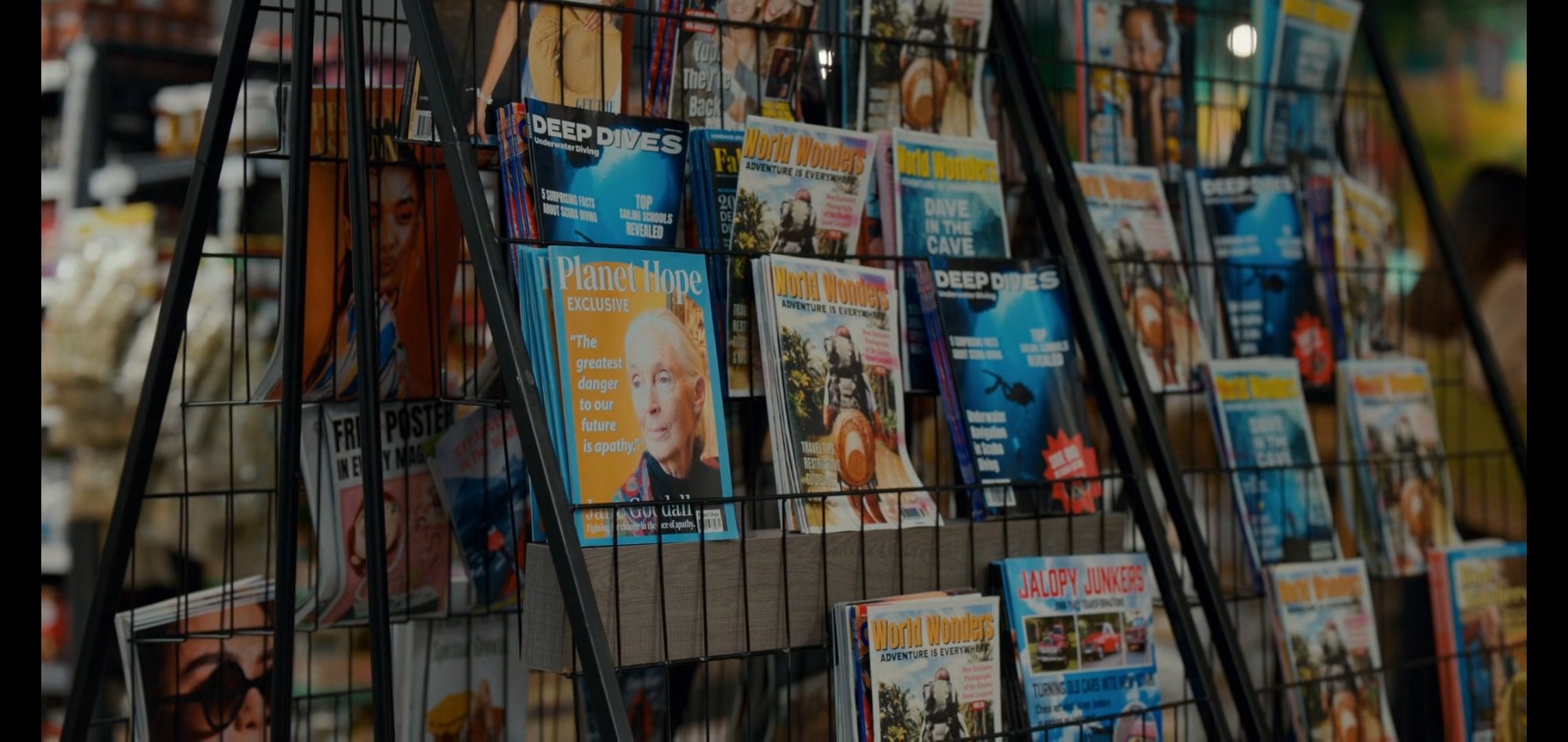Magazine rack with travel and diving magazines on display.