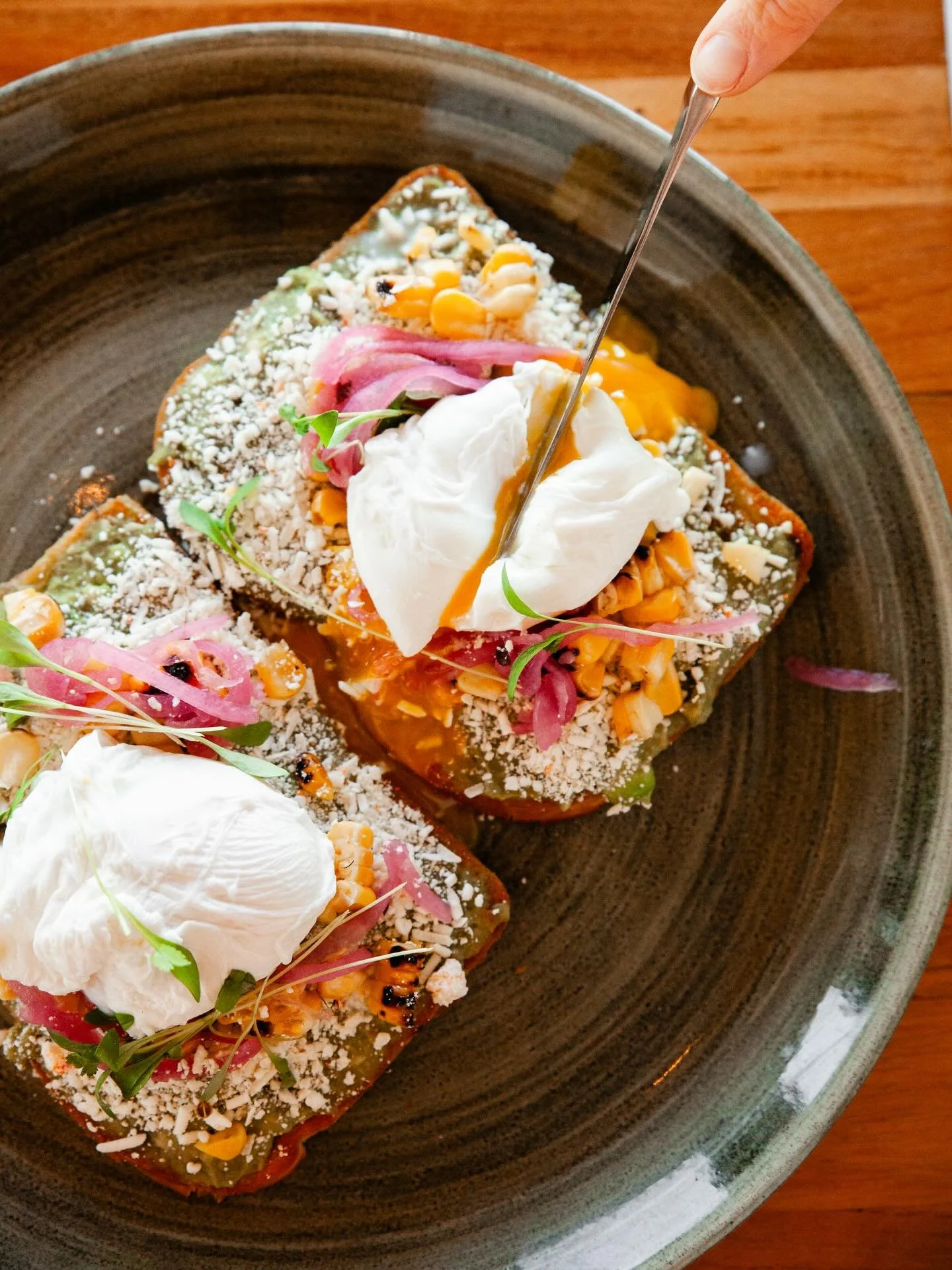 Our El Encanto avocado toast is sprinkled with cotija and topped with grilled corn and a perfectly poached egg. What better dish to eat as the sun shines in our windows?

📸 @eatmorecakebycandice