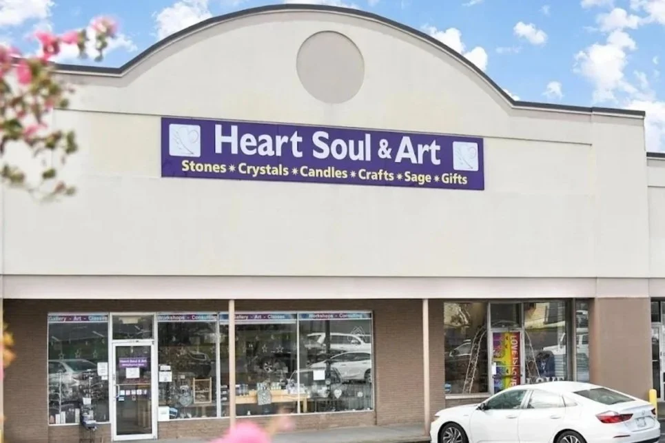 A building in a strip mall with a sign that reads "Heart, Soul, & Art".