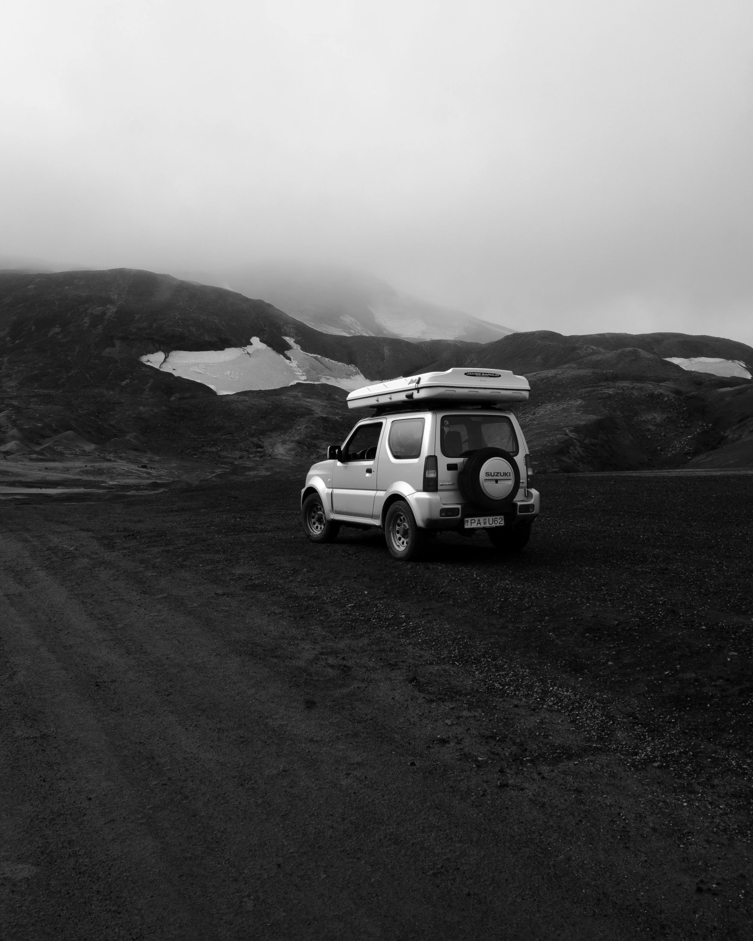 Suzuki Jimny 4x4 with rooftop on a gravel road in Iceland