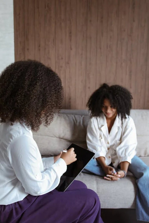 An image of a woman talking to an addiction therapist