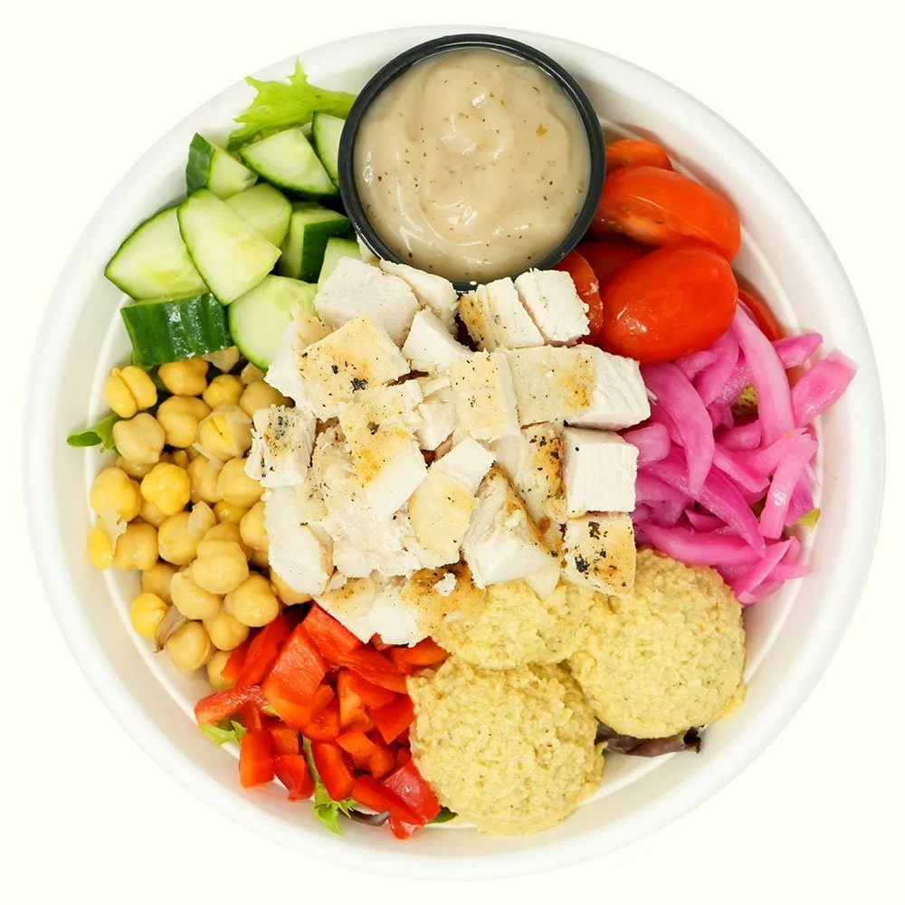 Yummus Chicken - All natural chicken, spring mix, hummus, bell peppers, cucumber, tomato, almonds, pickled onion, served with Mediterranean red wine dressing.