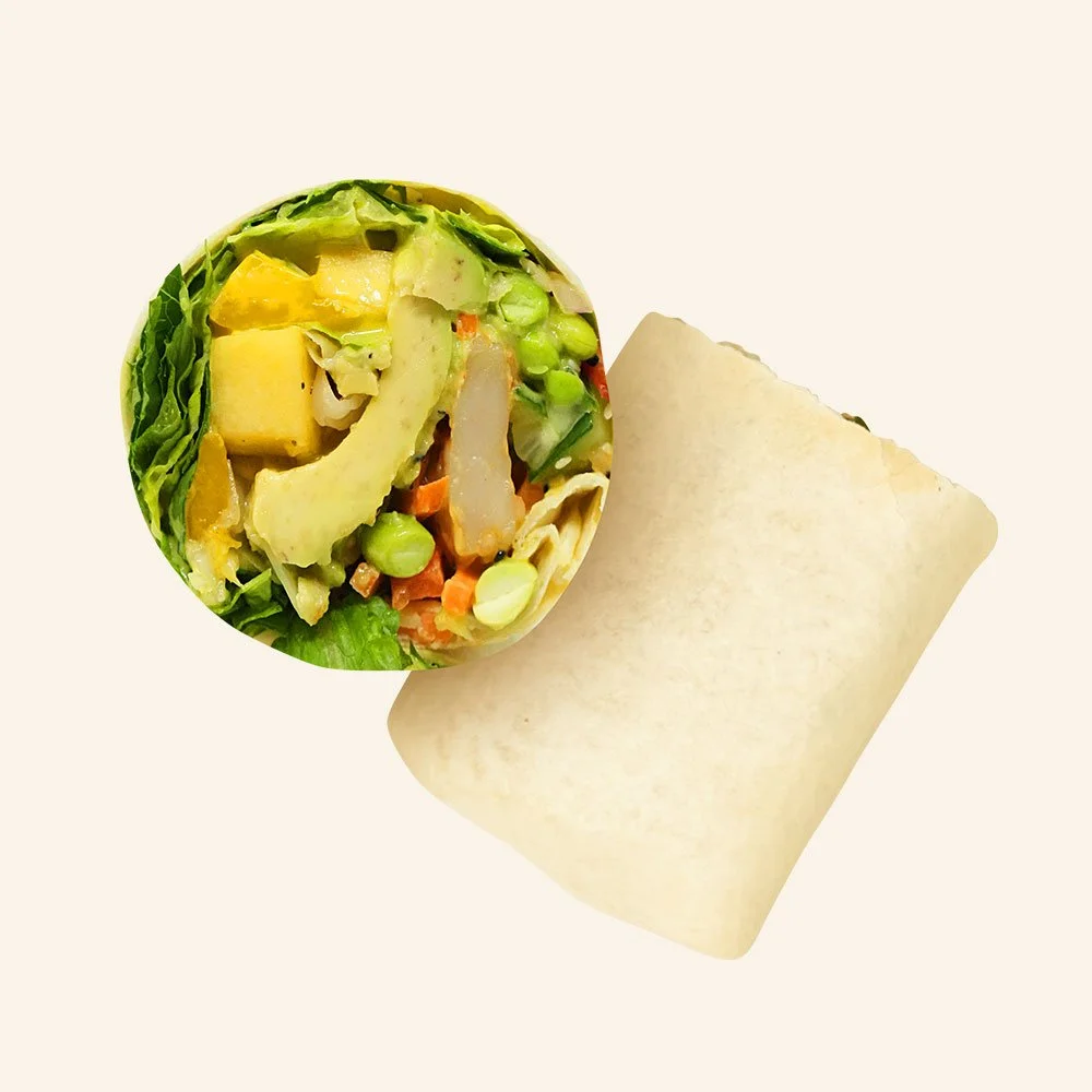 SHRIMP SPRING ROLL - Shrimp, romaine, Carolina slaw, carrots, cucumber, red peppers, edamame, mango peach chutney, avocado, sesame seeds, turmeric ginger dressing in a tortilla.