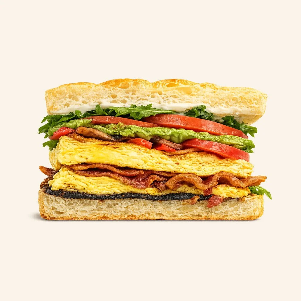ULTIMATE EGG SANDWICH - Omelette with peppers, onions and mushrooms topped with bacon, tomato, spinach, avocado, fig jam and whipped ricotta cheese on organic focaccia.