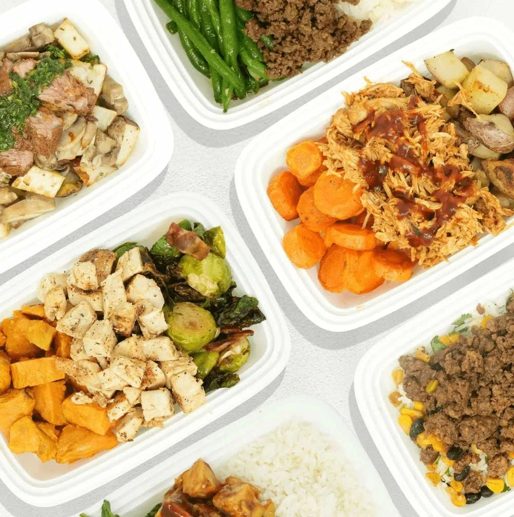 Assorted meal prep containers with cooked ground beef, shredded chicken with barbecue sauce, chopped roasted sweet potatoes, mixed vegetables, and rice.