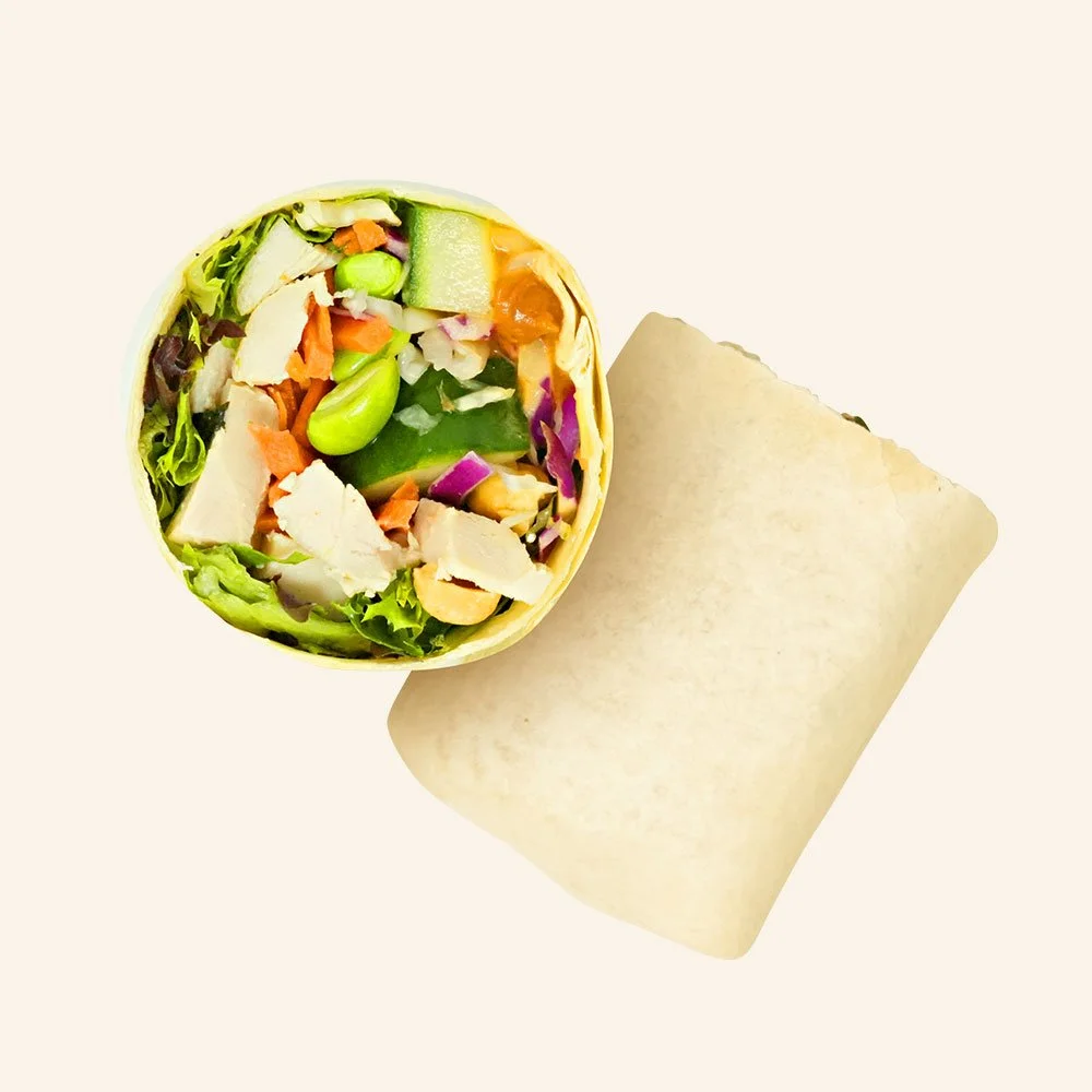THAI PEANUT CHICKEN - All natural chicken, pickled carrots, cucumber, edamame, roasted peanuts, spring mix, cabbage, Asian ginger peanut drizzle in a flour wrap. Contains Gluten
