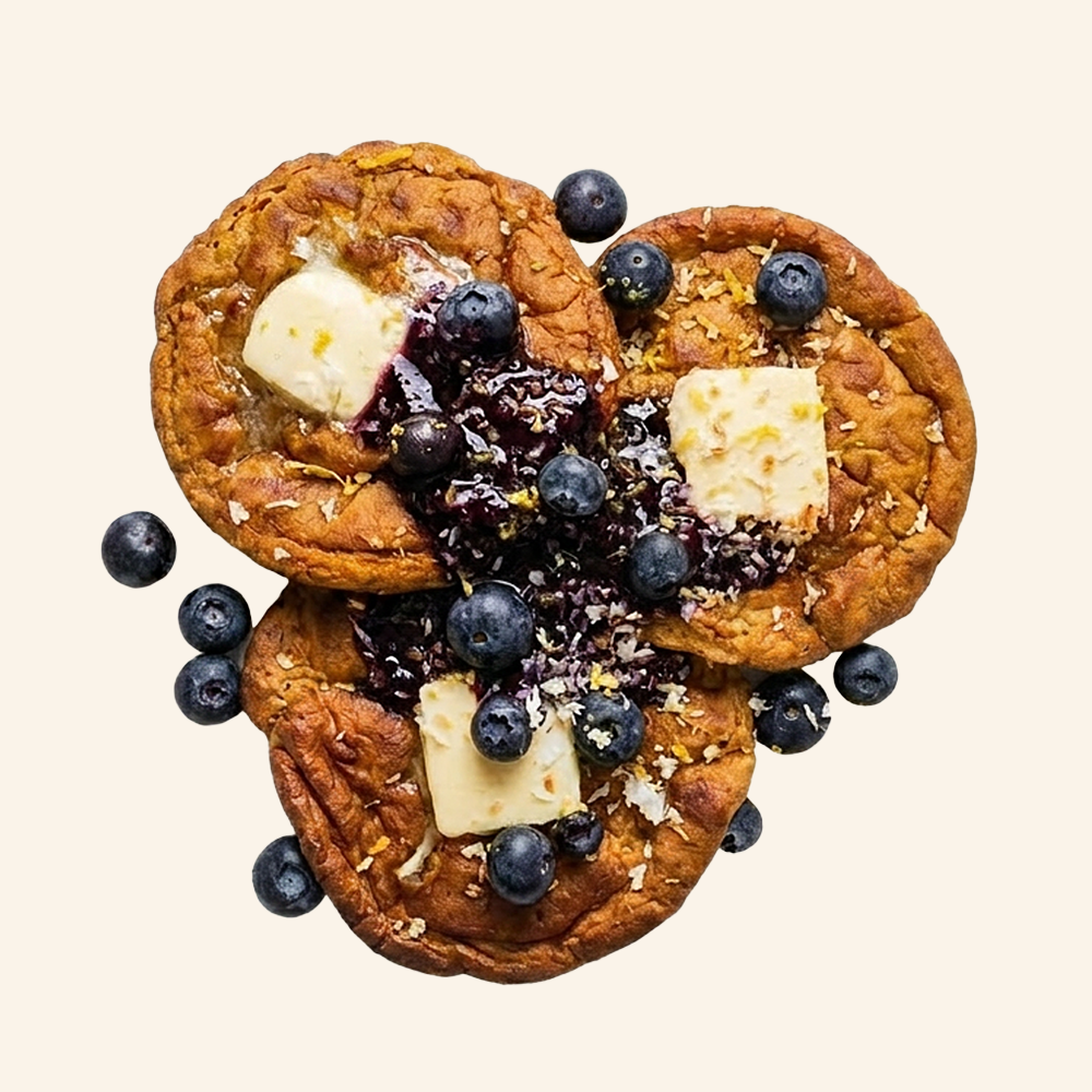 BLUEBERRY PANCAKES - Pancakes topped with a blueberry jam, plant based butter, fresh blueberries, toasted coconut and a lemon zest.
