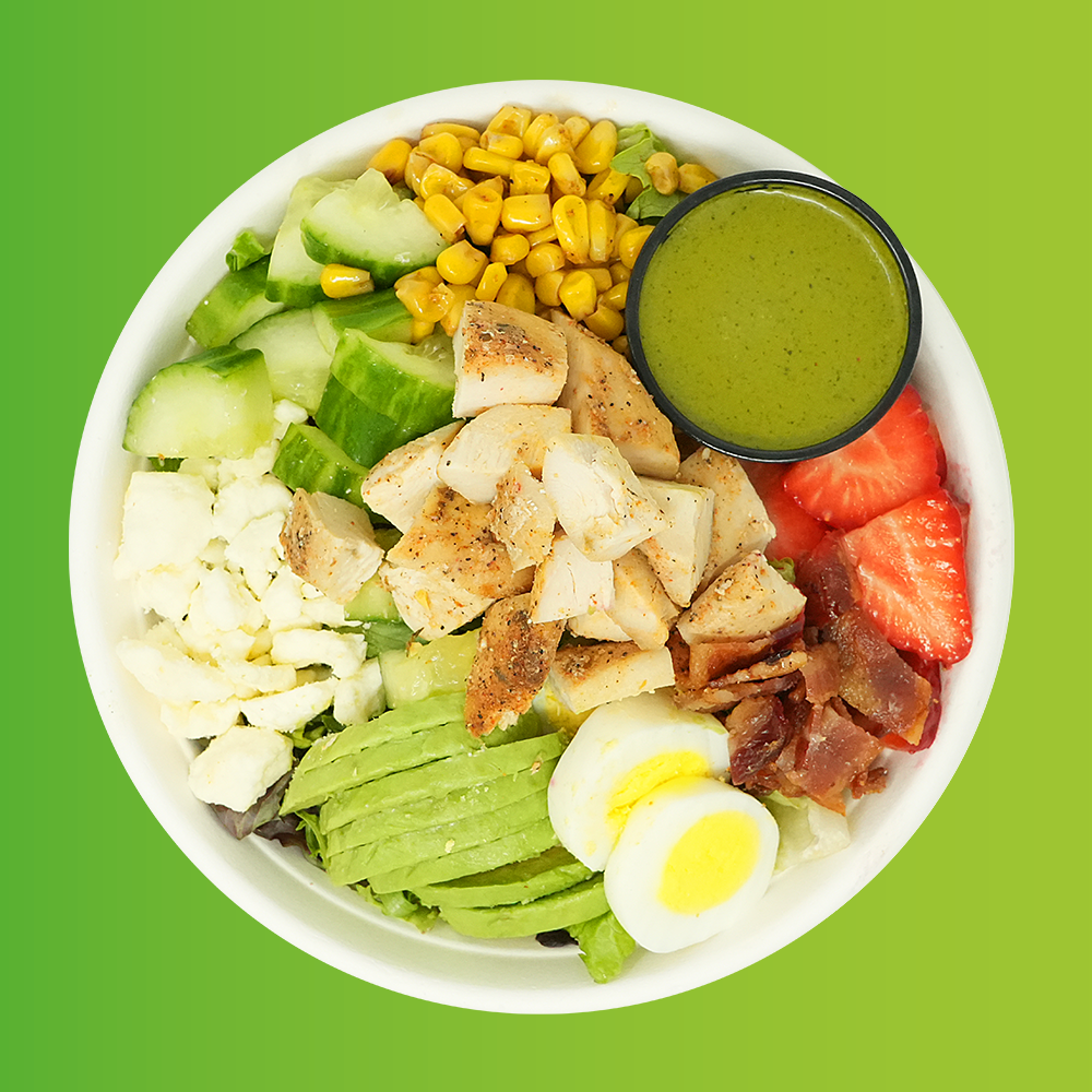 Summer Chicken Cobb - Blackened chicken, romaine, spring mix, cucumber, roasted corn, strawberry, bacon, hard boiled egg, feta and avocado with a cilantro vinaigrette.