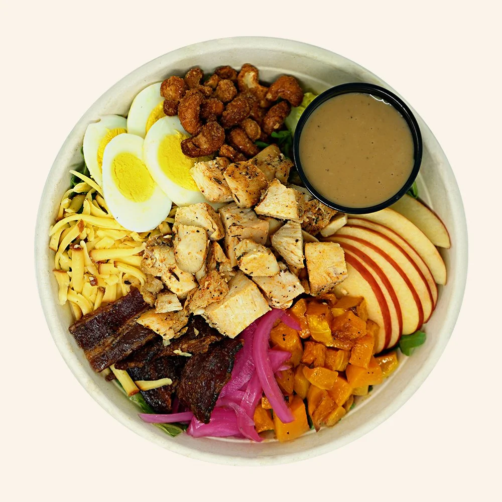FALL CHICKEN COBB - Blackened chicken, romaine, arugula, Honeycrisp apple, smoked Gouda, candied cashews, hard boiled egg, candied bacon, roasted butternut squash, pickled onions with a maple balsamic vinaigrette.