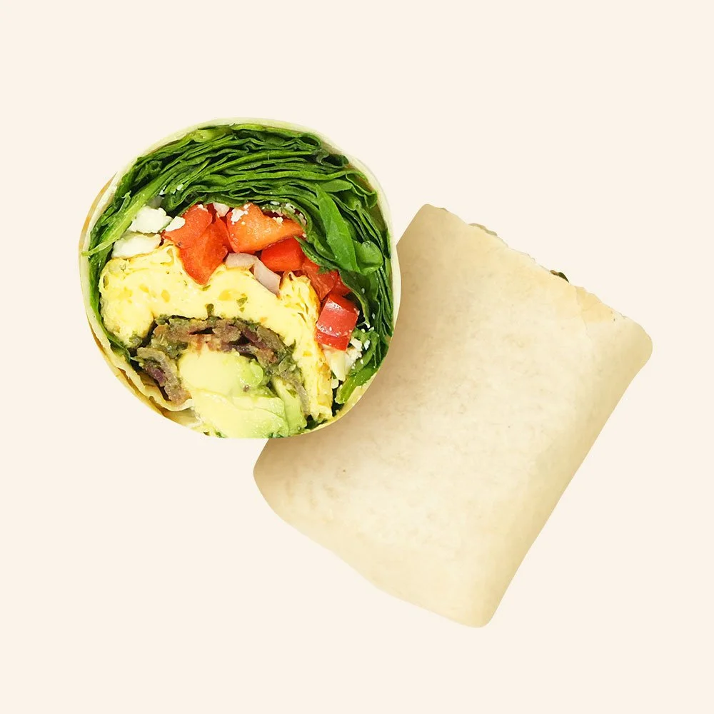 SUNRISE PESTO WRAP - Omelette with peppers and onions, spinach, bacon, avocado, feta and pesto in a tortilla.