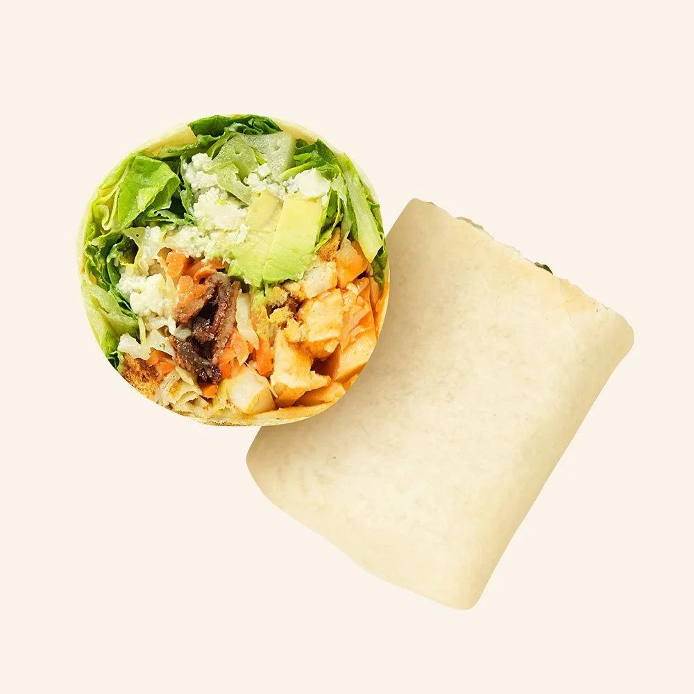 BUFFALO CHICKEN - All natural chicken, buffalo drizzle, gluten free bread crumbs, candied bacon, bleu cheese, romaine, Carolina slaw, pickled carrots, avocado in a tortilla.