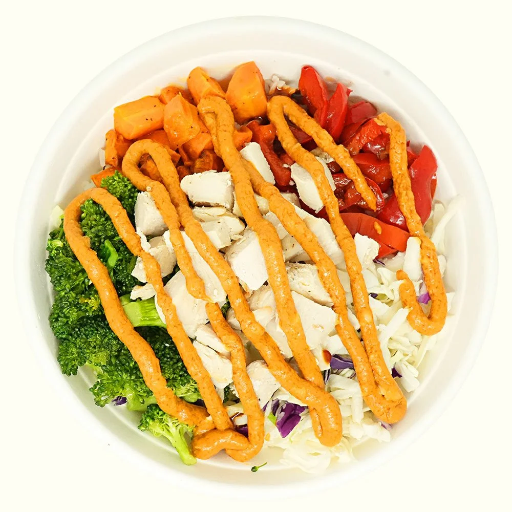 Chicken Thai Curry - All natural chicken, roasted carrots, cabbage, bell peppers, and broccoli, jasmine rice with a red curry peanut drizzle and red pepper flakes.