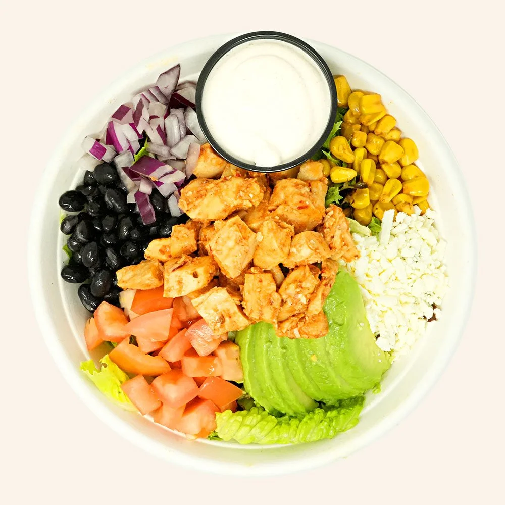SANTA FE CHICKEN - Chipotle chicken, romaine, spring mix, roasted corn, black beans, red onion, tomato, cheese blend, avocado, served with Baja ranch.