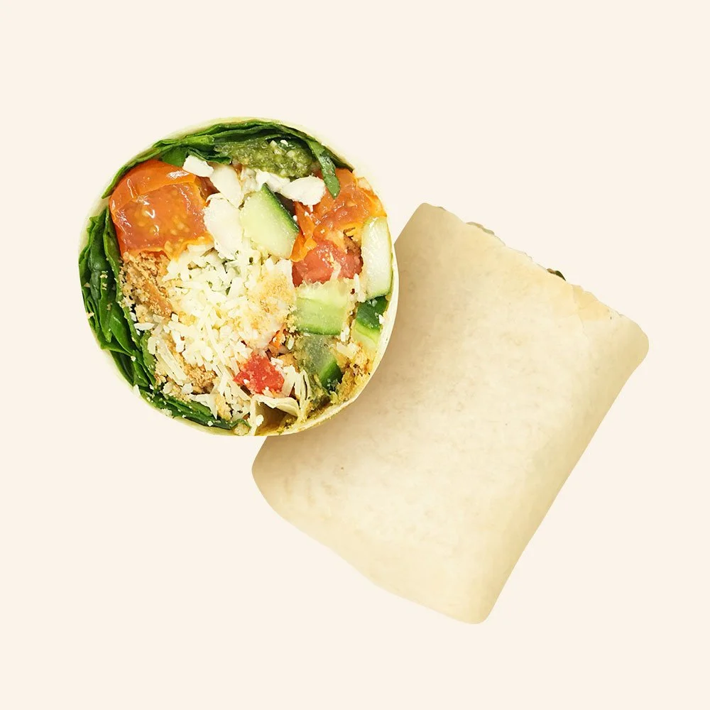 CHICKEN PESTO PARM - All natural chicken, gluten free bread crumbs, pesto, blistered tomatoes, spinach, cucumber, bell pepper, parmesan in a tortilla.