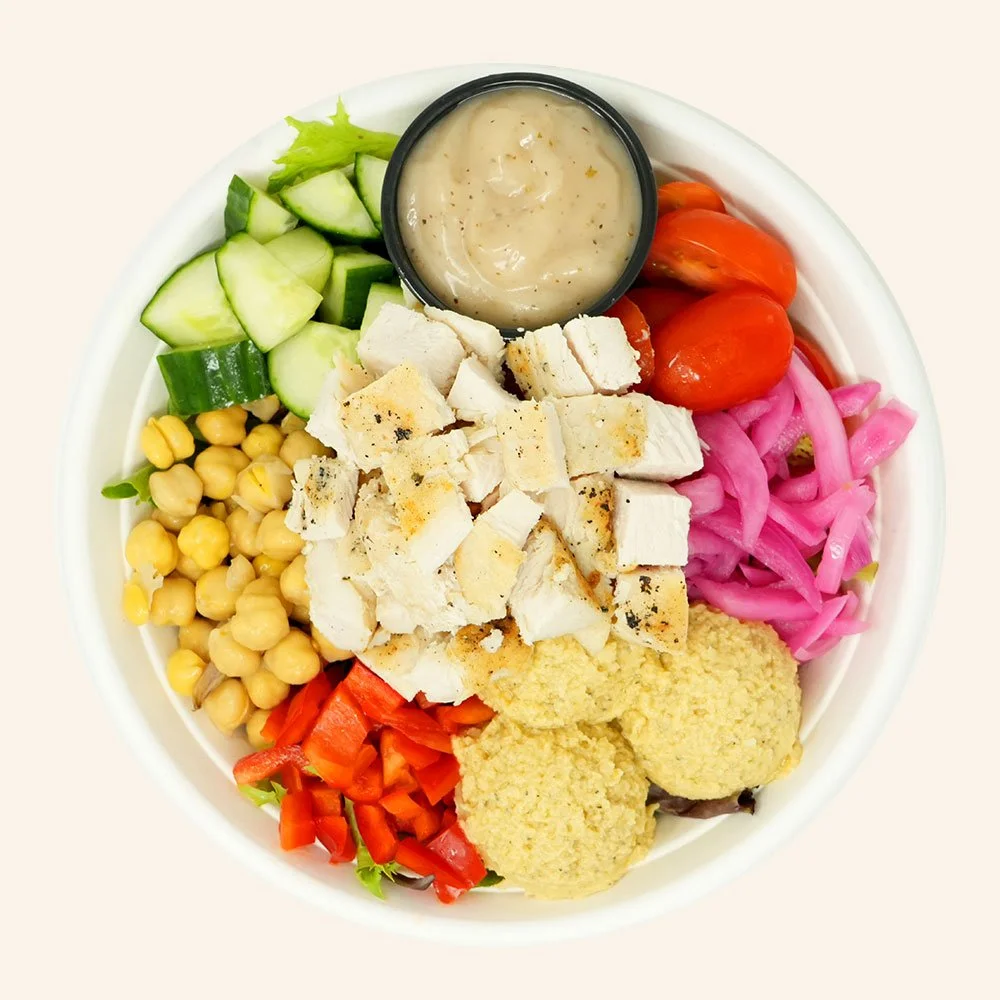 YUMMUS CHICKEN - All natural chicken, spring mix, hummus, bell peppers, cucumber, tomato, almonds, pickled onion, served with Mediterranean red wine dressing.