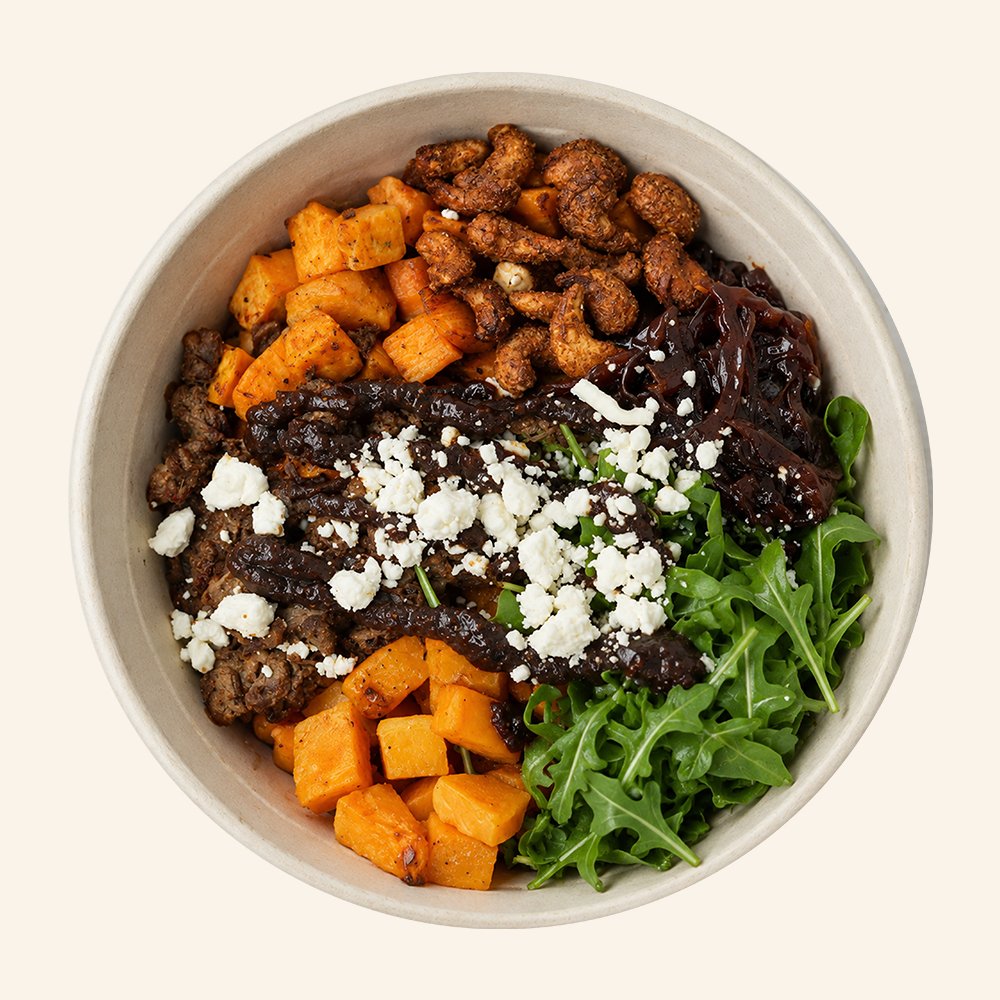 HARVEST BRAISED BEEF - Slow roasted braised beef, roasted sweet potato, goat cheese, roasted butternut squash, candied cashews, apple onion chutney, arugula with a fig jam drizzle.