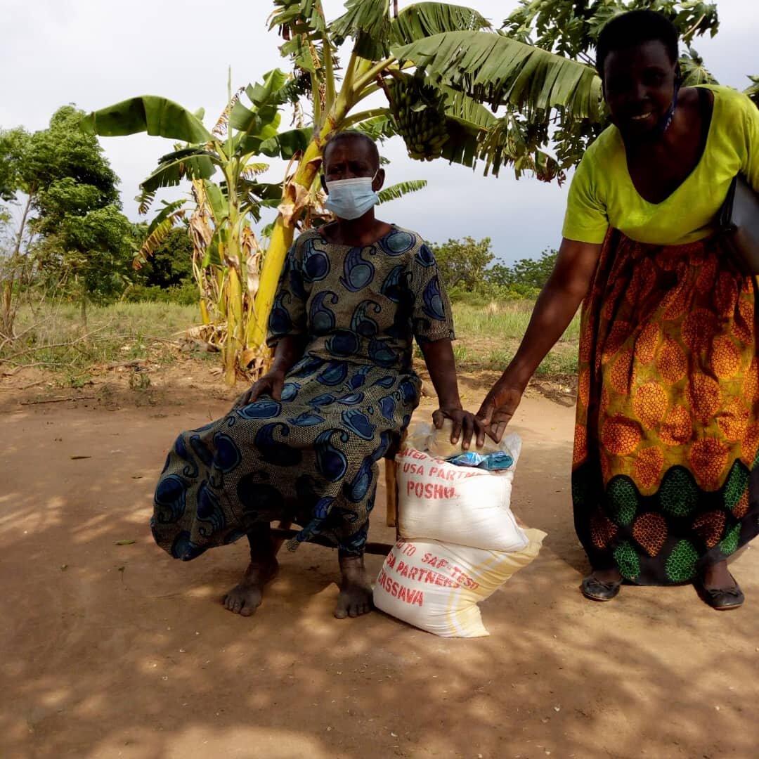 elderly_woman_receiving_food_supplies_from_SAF-Teso_staff[1].jpg