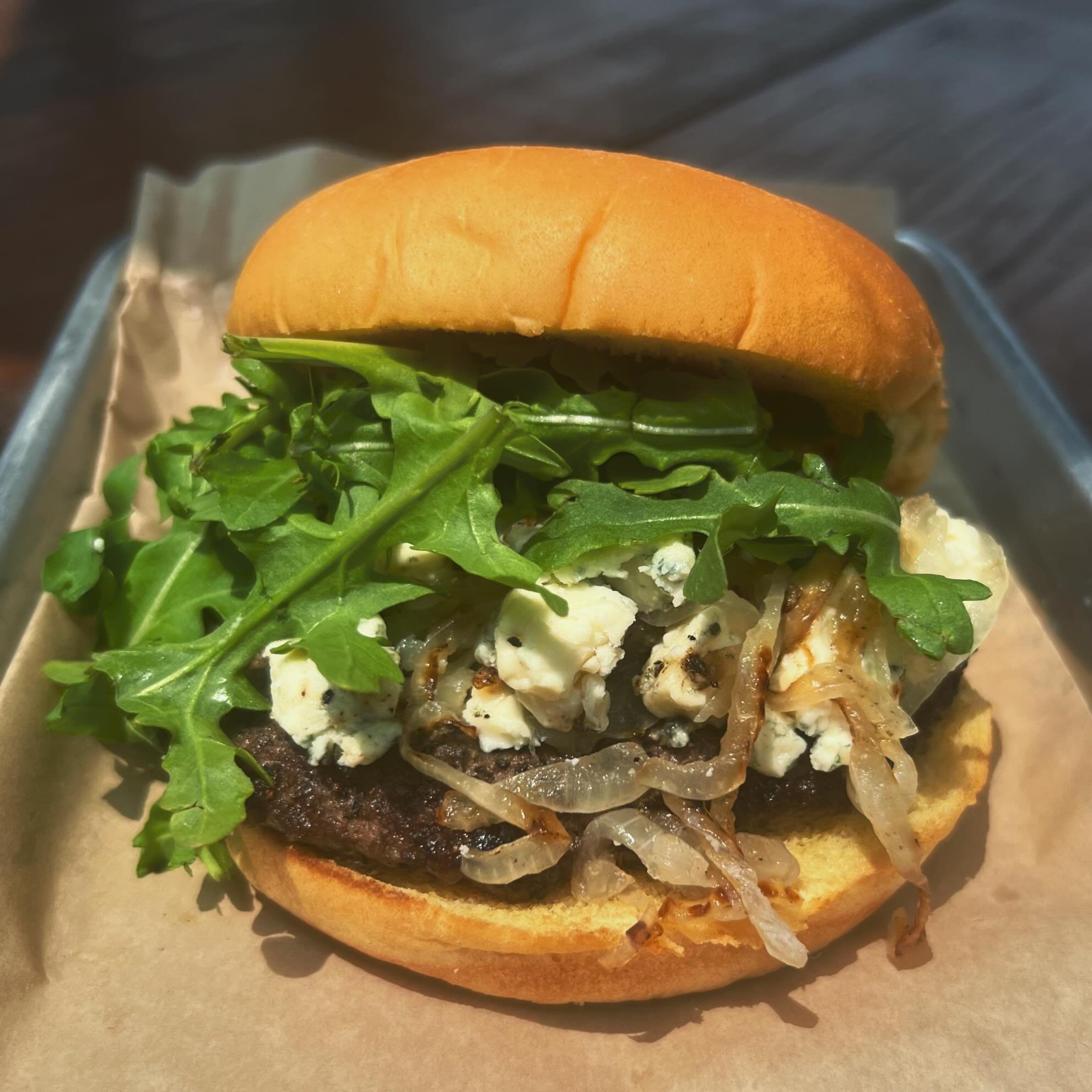 Burger special of the month.
&ldquo;The blue&rdquo;: beef patty seasoned with activated charcoal seasoning, topped with blue cheese, arugula and caramelized vidalia onions on a potato bun.