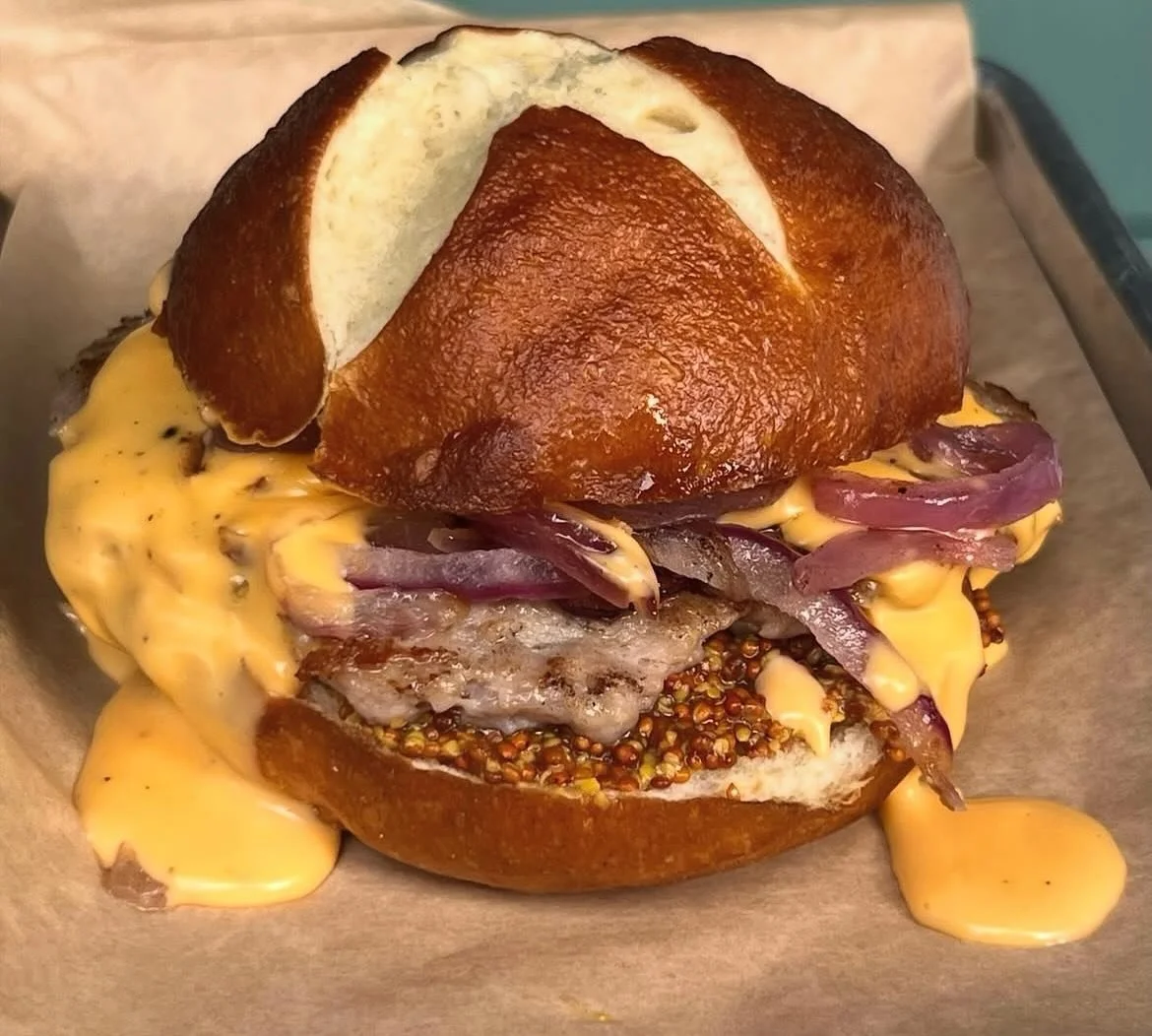 Burger of the month &ldquo;Oktoberfest Burger&rdquo;  Bratwurst seasoned pork patty with wholegrain mustard, caramelized onions topped with beer cheese on a pretzel bun.