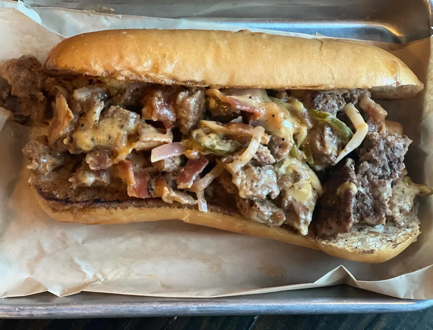 &ldquo;Chop it like it&rsquo;s hot&rdquo; 
Our version of a chopped cheese sandwich, 8 oz adobo seasoned beef, grilled onions, beer cheese, bread &amp; butter jalapenos and bacon on a hoagie roll.
Sandwich  of the month!