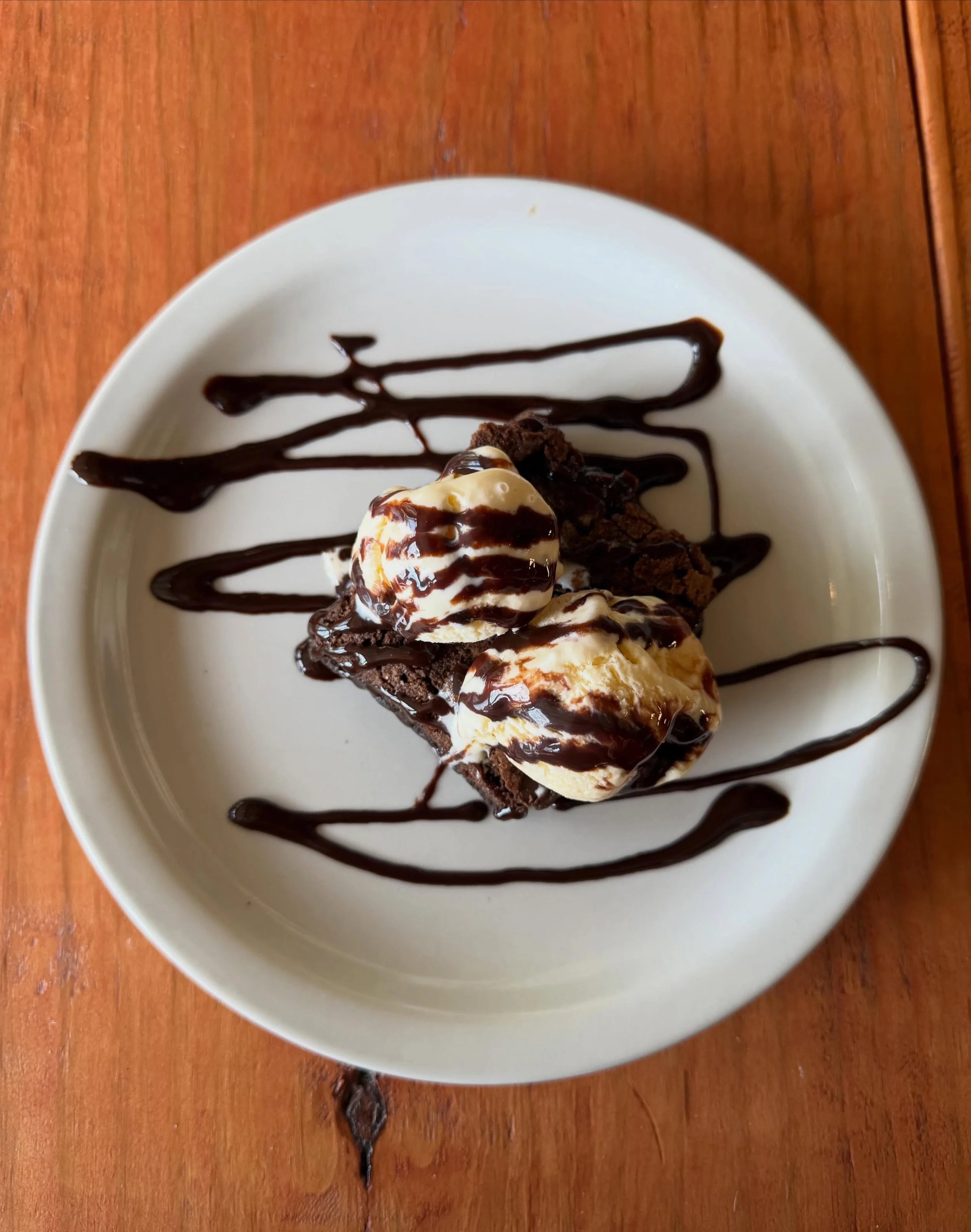 We have a new dessert on the menu, chocolate chip brownie with ice cream and a chocolate sauce drizzle