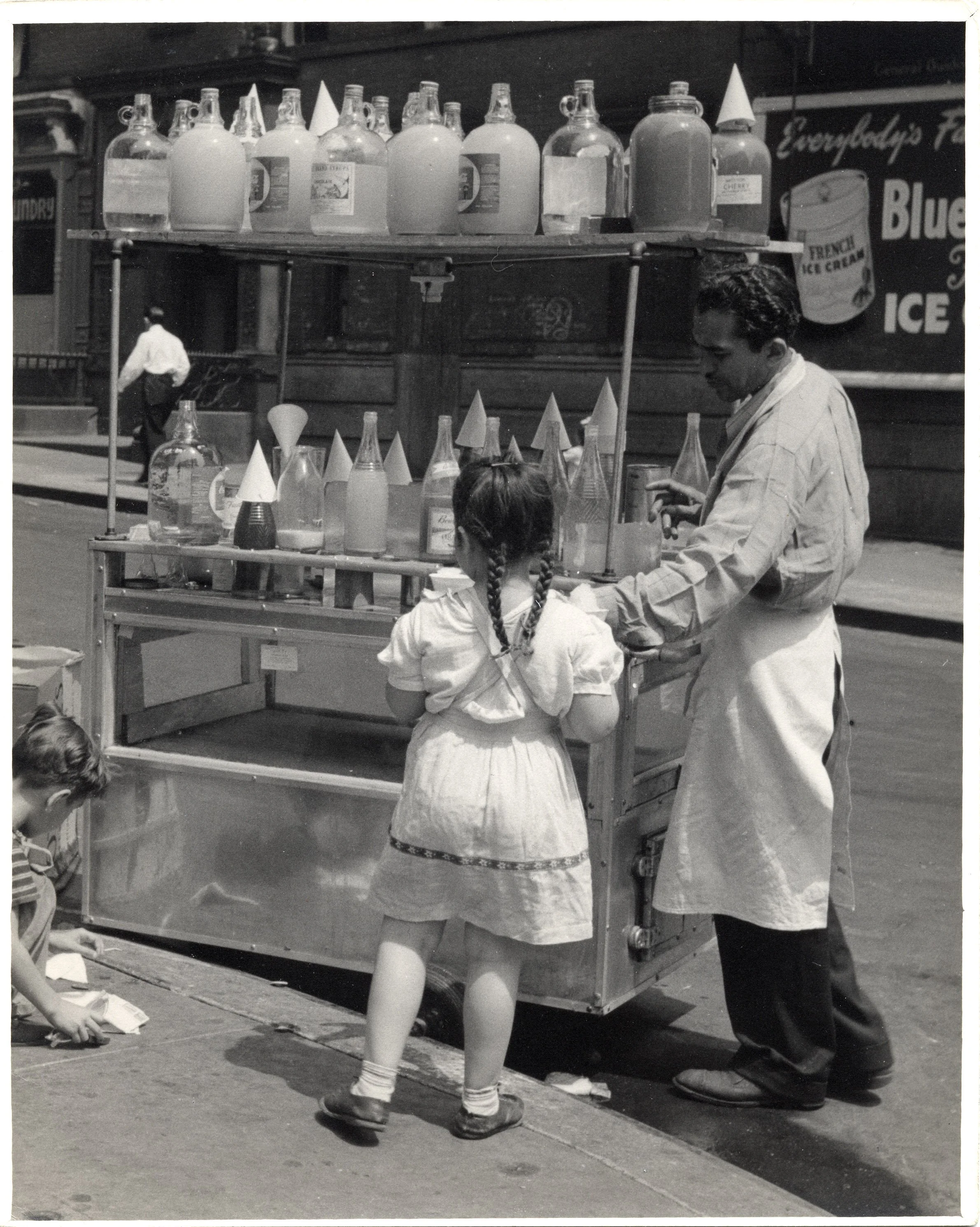 Street vendor giving young girl ice cone