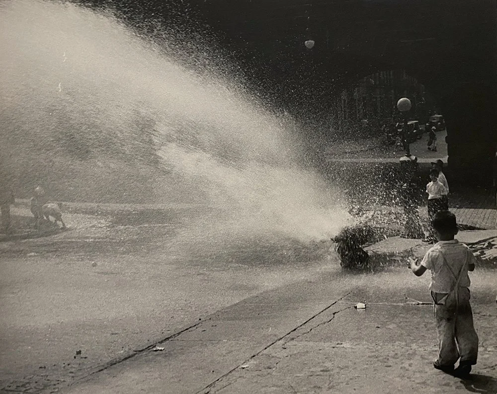 Children playing with water coming out from hydrant